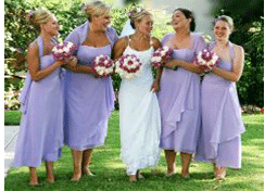 Bridesmaids in lavender dresses with the bride